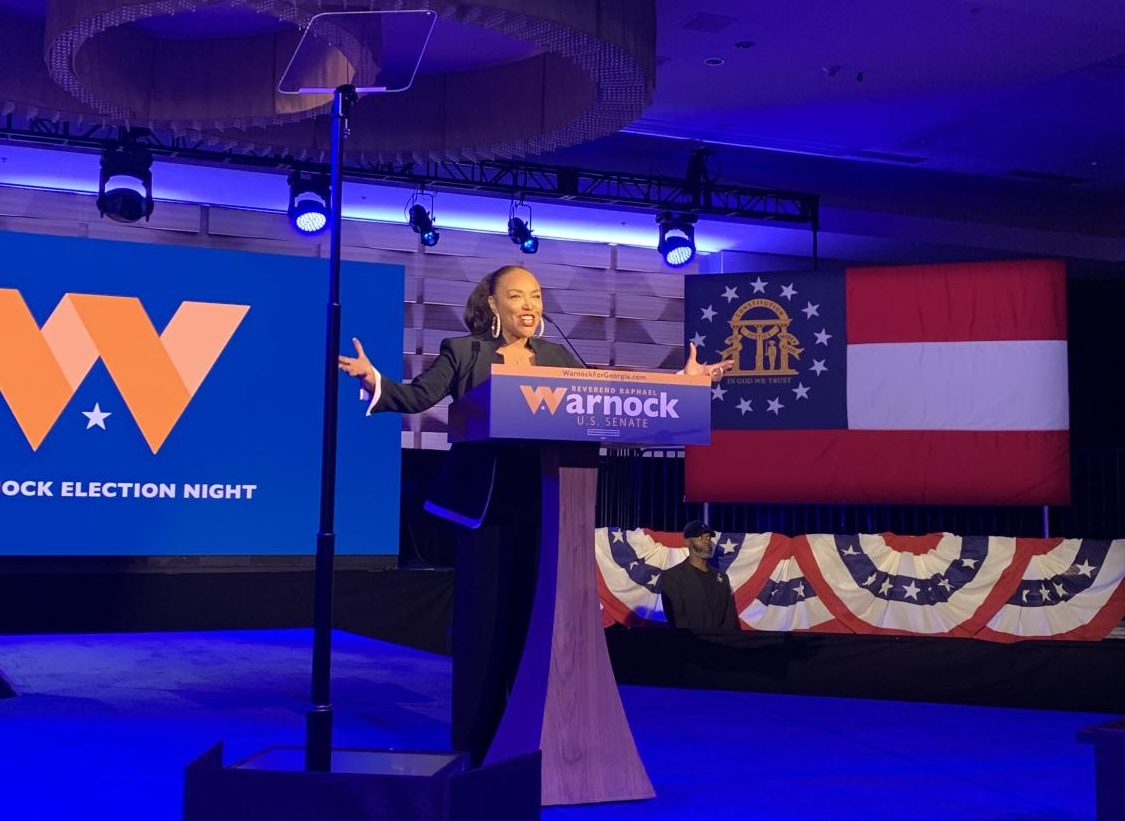 Image of actress making speech at Warnock election night party